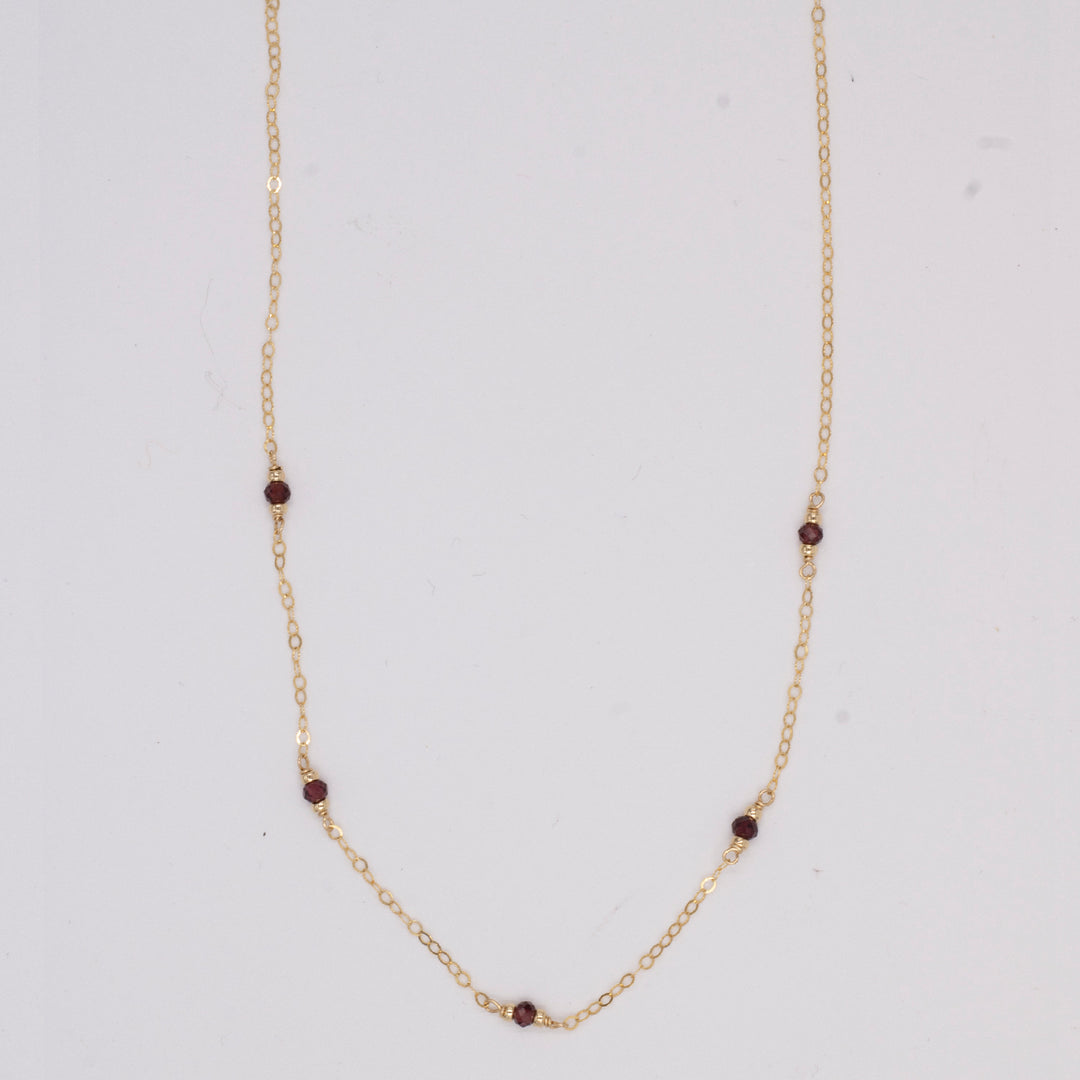 golden rondelle necklace - garnet coin charm - workshopunderground.com