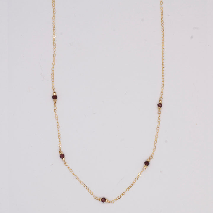 golden rondelle necklace - garnet coin charm - workshopunderground.com