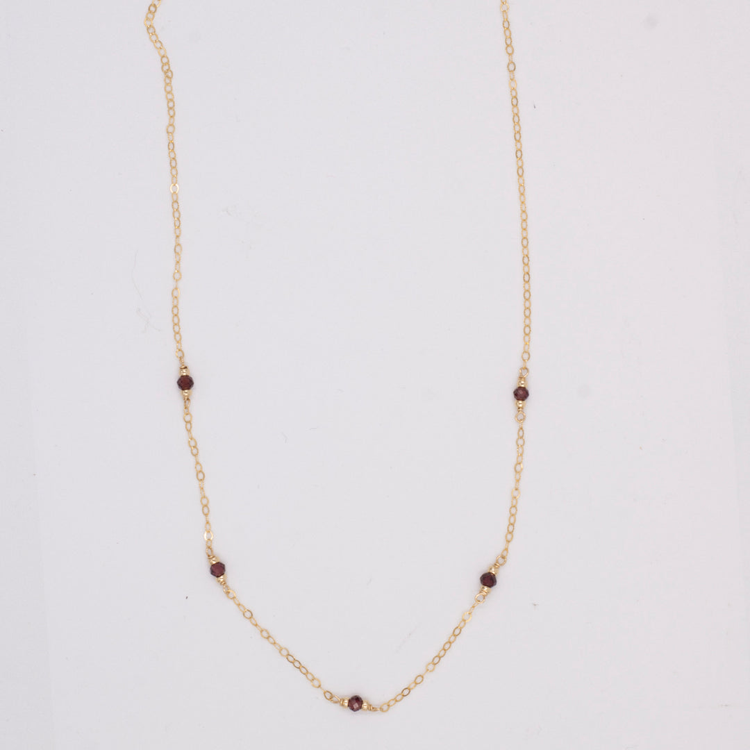 golden rondelle necklace - garnet coin charm - workshopunderground.com