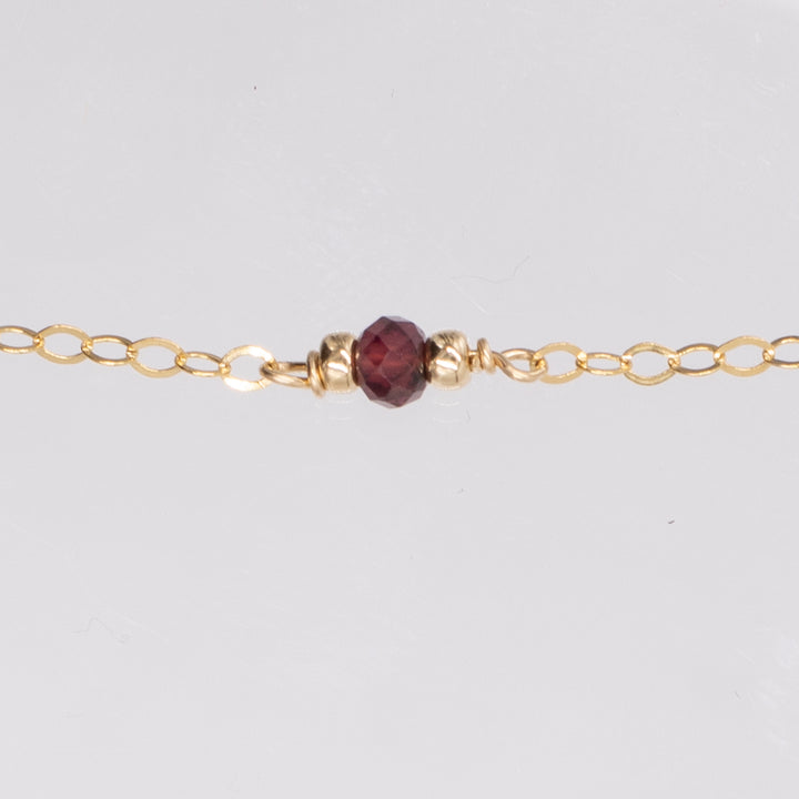 golden rondelle necklace - garnet coin charm - workshopunderground.com